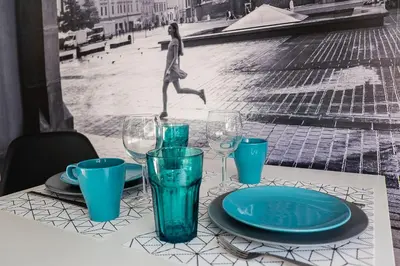a table with blue glasses and a plate on it at Apartament Turkusowy - Kraków, Kazimierz in Kraków
