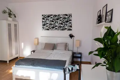 a bedroom with a bed and a painting on the wall at Apartament Turkusowy - Kraków, Kazimierz in Kraków