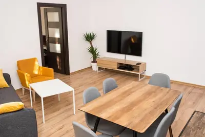 a living room with a table and a tv at WONDER CRACOW in Kraków