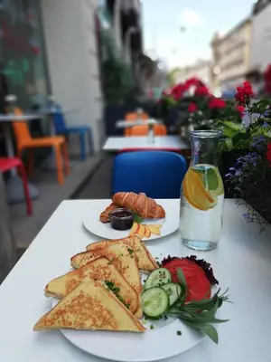 a table with two plates of food and a drink at WONDER CRACOW in Kraków