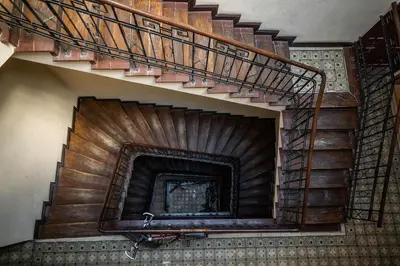 a spiral staircase in a building with a fire place at WONDER CRACOW in Kraków