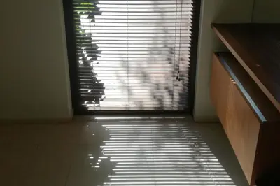 a door to a room with a window with blinds at Apartment with GARDEN in CITY CENTER in Kraków