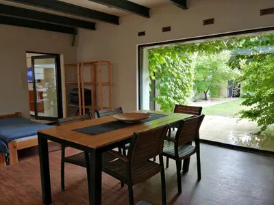 a dining room with a table and chairs and a window at Apartment with GARDEN in CITY CENTER in Kraków