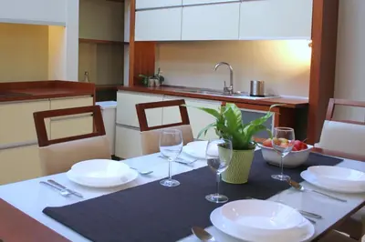a table with plates and wine glasses on it at Apartment with GARDEN in CITY CENTER in Kraków