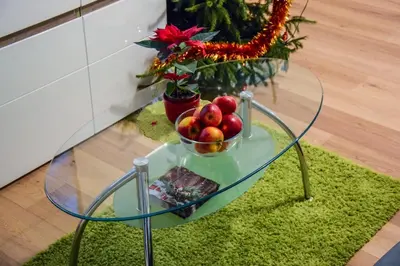 a glass table with a bowl of apples on it at Mogilska Tower + garaż in Kraków
