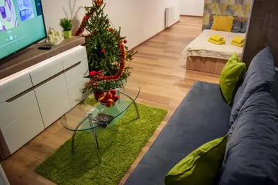 a living room with a christmas tree and a television at Mogilska Tower + garaż in Kraków
