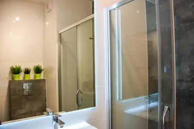 a bathroom with a shower and a sink at Mogilska Tower + garaż in Kraków