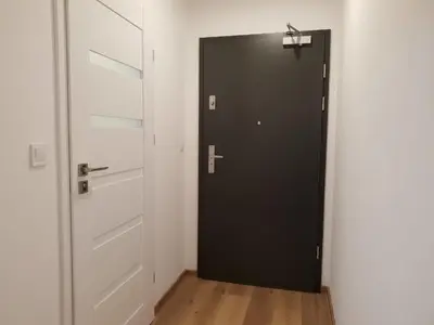 a black door with a cross on it in a room at Mogilska Tower + garaż in Kraków