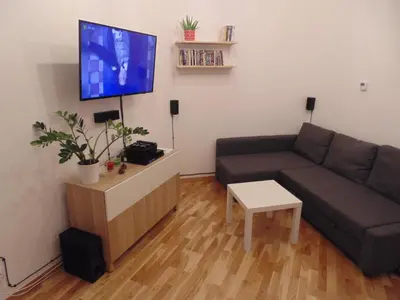 a living room with a couch and a flat screen tv at Apartment Lenartowicza in Kraków