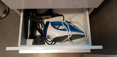 a white and blue appliance sitting in a drawer at Apartment Lenartowicza in Kraków