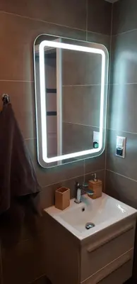 a bathroom with a sink and a mirror at Apartment Lenartowicza in Kraków