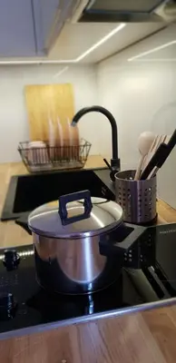 a pot on top of a stove in a kitchen at Apartment Lenartowicza in Kraków