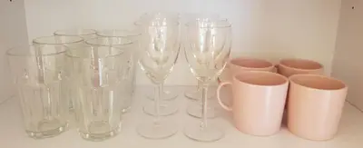a group of glass vases and cups on a counter at Apartment Lenartowicza in Kraków