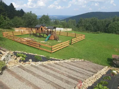 a playground in a field with at Bacówka na Zadzielu in Laskowa