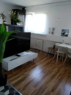 a living room with a couch and a table at Apartament Mazowiecka 125 in Kraków