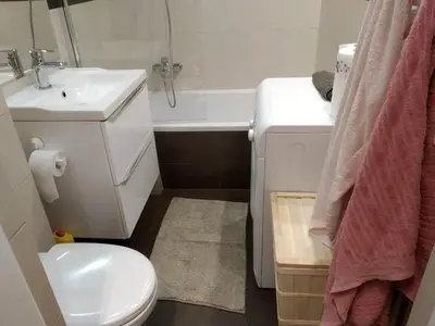 a small bathroom with a toilet and a sink at Apartament Mazowiecka 125 in Kraków