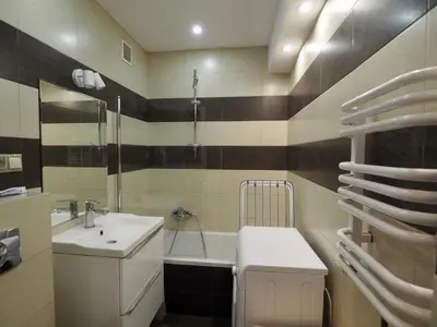 a bathroom with a sink and a toilet and a tub at Apartament Mazowiecka 125 in Kraków
