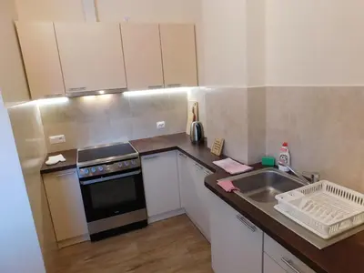 a kitchen with a table with chairs and a refrigerator at KAJA Zawoja in Zawoja