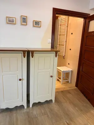 a kitchen with white cabinets and a counter top at KAJA Zawoja in Zawoja