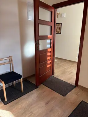 a bedroom with a bed and a chair in it at KAJA Zawoja in Zawoja