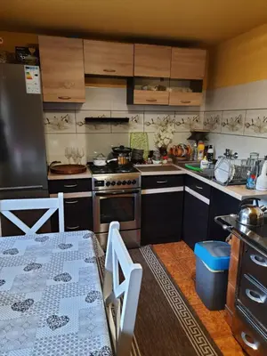 a kitchen with a stove and a table in it at Pokoje u Zajdy in Zawoja