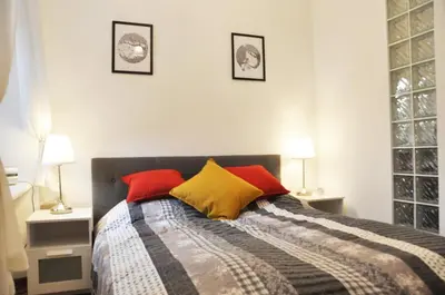a bedroom with a bed with colorful pillows at Tenczyńska 4 by Homeprime in Kraków