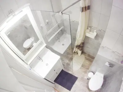 a bathroom with a glass shower and a toilet at Tenczyńska 4 by Homeprime in Kraków