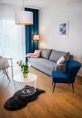 a living room with a couch and a table at Apartamenty Rakowicka WAWELOFTS in Kraków