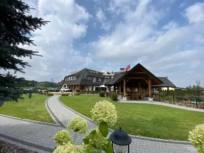 a large house with a path leading to it at Hotel Tadeusz in Uszew