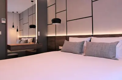 a bedroom with a large white bed with two pillows at Lubicz Luxury Apartment in Kraków
