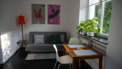 a living room with a couch and a table at Lovely Bubbly Apartment in Kraków