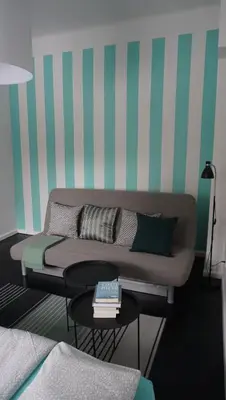 a living room with a couch and a table at Lovely Bubbly Apartment in Kraków