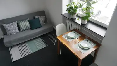 a small living room with a table and a couch at Lovely Bubbly Apartment in Kraków