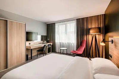 a hotel room with a bed and a desk at Park Inn by Radisson Krakow in Kraków