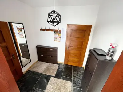 a kitchen with a table and a refrigerator at Domek w Chmurach in Kicznia