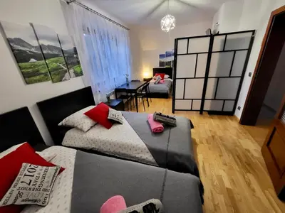 a room with two beds and a table and chairs at Domek w Chmurach in Kicznia