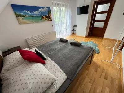 a small bedroom with a bed with two pillows at Domek w Chmurach in Kicznia