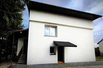 a white house with a window on the side of it at Apartament Sofia Agroturystyka in Ryczów
