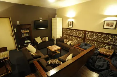 a living room with couches and a tv at Hostel Deco in Kraków