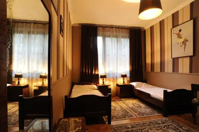 a bedroom with a bed and a window and a mirror at Hostel Deco in Kraków