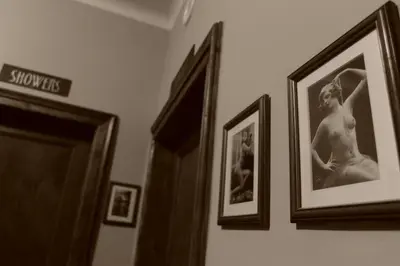 a group of framed pictures hanging on a wall at Hostel Deco in Kraków