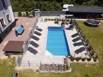 an overhead view of a swimming pool with chairs and people at Willa Cicha in Rabka