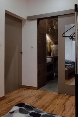 a room with a mirror and a bedroom at Willa Cicha in Rabka
