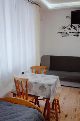 a living room with a table and chairs and a couch at Willa Cicha in Rabka