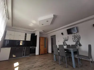 a kitchen and dining room with a table and chairs at Willa Cicha in Rabka