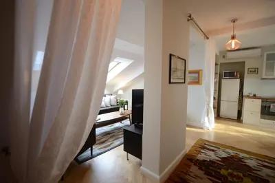 a hallway with a living room and a kitchen at Crystal Suites Old Town in Kraków