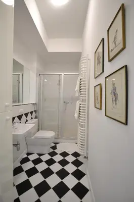 a white bathroom with a toilet and a shower at Crystal Suites Old Town in Kraków