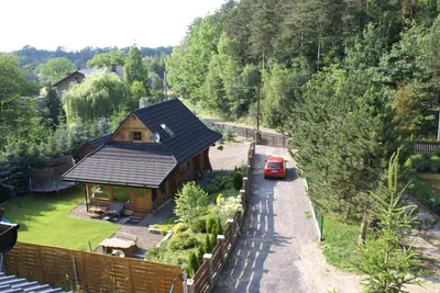 an aerial view of a house with a car parked next to it at CHATA PACHNĄCA LASEM in Andrychów