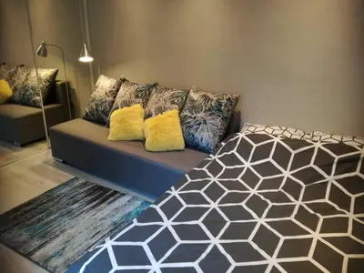 a couch with pillows on it in a room at Kremerowska Apartment in Kraków