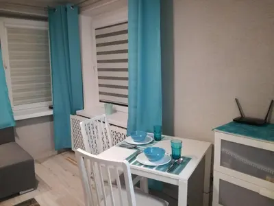 a small white table with two blue dishes on it at Kremerowska Apartment in Kraków